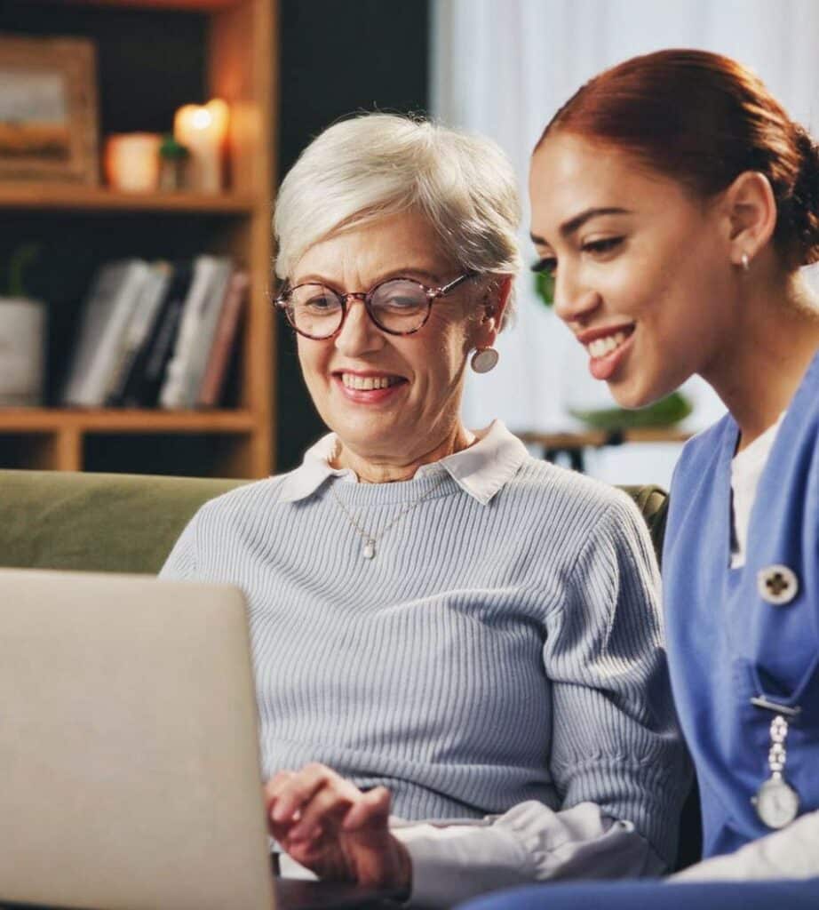 Caregiver assist Elderly woman with her laptop